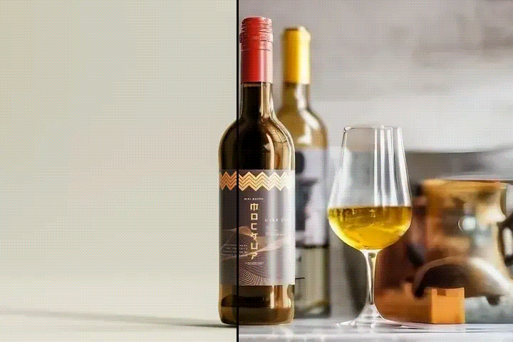 Red-capped wine bottle with black and gold label next to a glass of white wine.